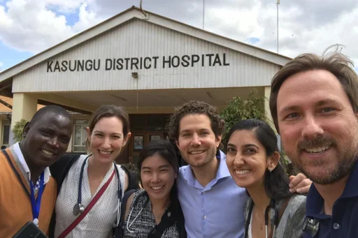 Dr Tymchuk with residents in front of a building