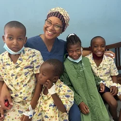 A picture of Dr. Amado with children in Maputo Central Hospital, received with parental consent. Photo credit Massada da Rocha.