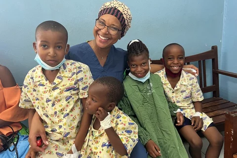 A picture of Dr. Amado with children in Maputo Central Hospital, received with parental consent. Photo credit Massada da Rocha.